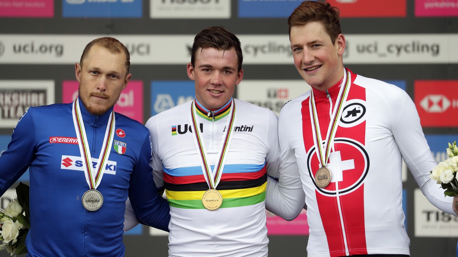 Denmark&#039;s Mads Pedersen, center, winer of the men elite race, stands on the podium with second placed Italy&#039;s Matteo Trentin, left, and third placed Switzerland&#039;s Stefan Kung, at the ro ...