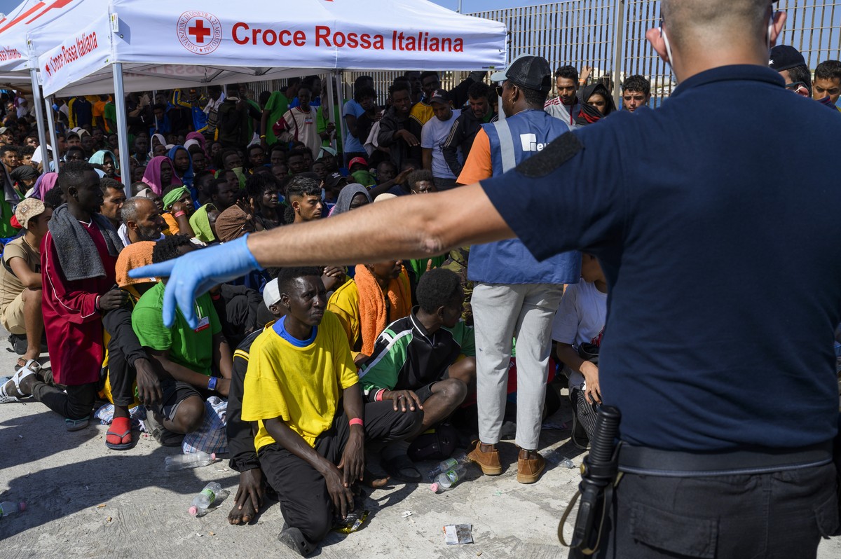 FILE - Migrants wait to be transferred from Lampedusa Island, Italy, Sept. 15, 2023. Albania has agreed to host two migrant processing centers on its territory that will be run by Italy under a deal t ...