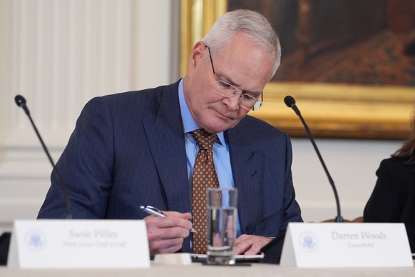 Darren Woods, CEO of ExxonMobil, takes notes before President Donald Trump speaks during a meeting with oil executives in the East Room of the White House, Friday, Jan. 9, 2026, in Washington. (AP Pho ...