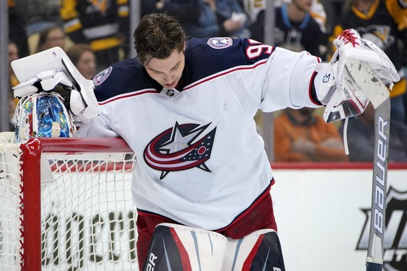 Columbus Blue Jackets goaltender Elvis Merzlikins collects himself during the second period of an NHL hockey game against the Pittsburgh Penguins in Pittsburgh, Friday, April 29, 2022. (AP Photo/Gene  ...