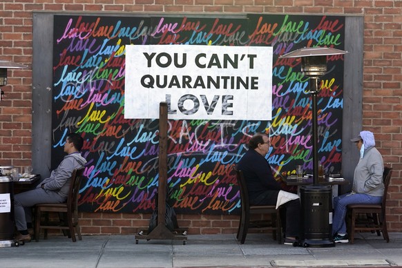 FILE - In this Nov. 23, 2020, file photo a COVID-19-themed mural reads &quot;You Can&#039;t Quarantine Love,&quot; outside of a restaurant in Santa Monica, Calif. Los Angeles County has announced a ne ...