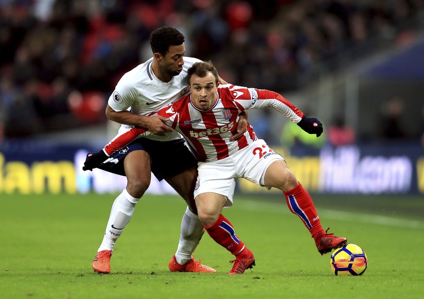 Tottenham Hotspur&#039;s Mousa Dembele, top, and Stoke City&#039;s Xherdan Shaqiri during their English Premier League soccer match at Wembley Stadium, London, Saturday, Dec. 9, 2017. (Adam Davy/PA vi ...