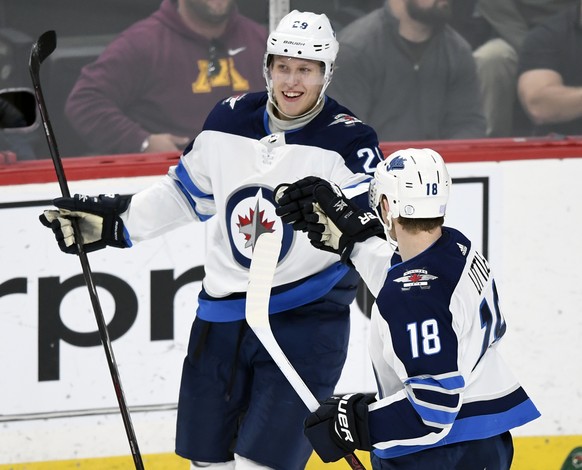 Winnipeg Jets&#039; Bryan Little (18) congratulates right wing Patrik Laine (29), of Finland, on a goal against the Minnesota Wild during the first period of an NHL hockey game Friday, Nov. 23, 2018,  ...