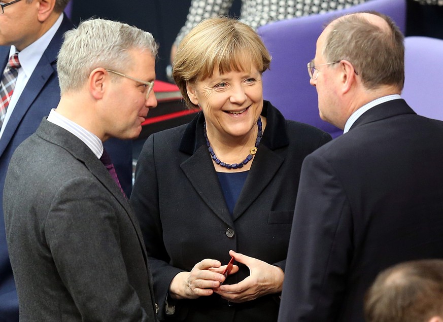 epa04648623 German Chancellor Angela Merkel (C) talks to MPs Norbert Roettgen (L) and Peer Steinbrueck (R) during a parliamentary debate on the curbing of rent rises, in the German Bundestag in Berlin ...