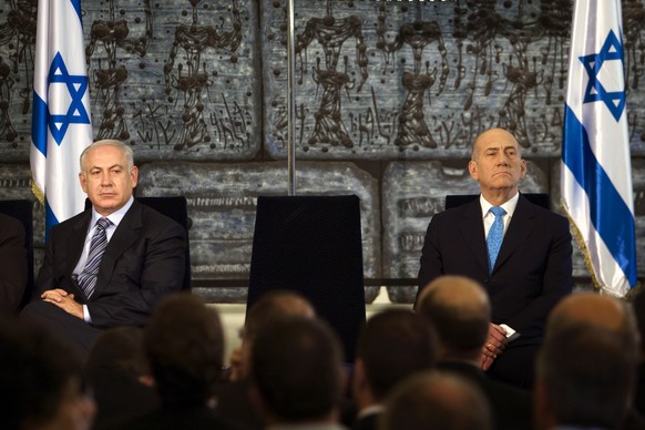 FILE - Outgoing Prime Minister Ehud Olmert, right, sits with new Israeli Prime Minister Benjamin Netanyahu during a handover ceremony at the president's residence in Jerusalem, Wednesday, April 1, 200 ...
