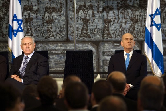 FILE - Outgoing Prime Minister Ehud Olmert, right, sits with new Israeli Prime Minister Benjamin Netanyahu during a handover ceremony at the president&#039;s residence in Jerusalem, Wednesday, April 1 ...