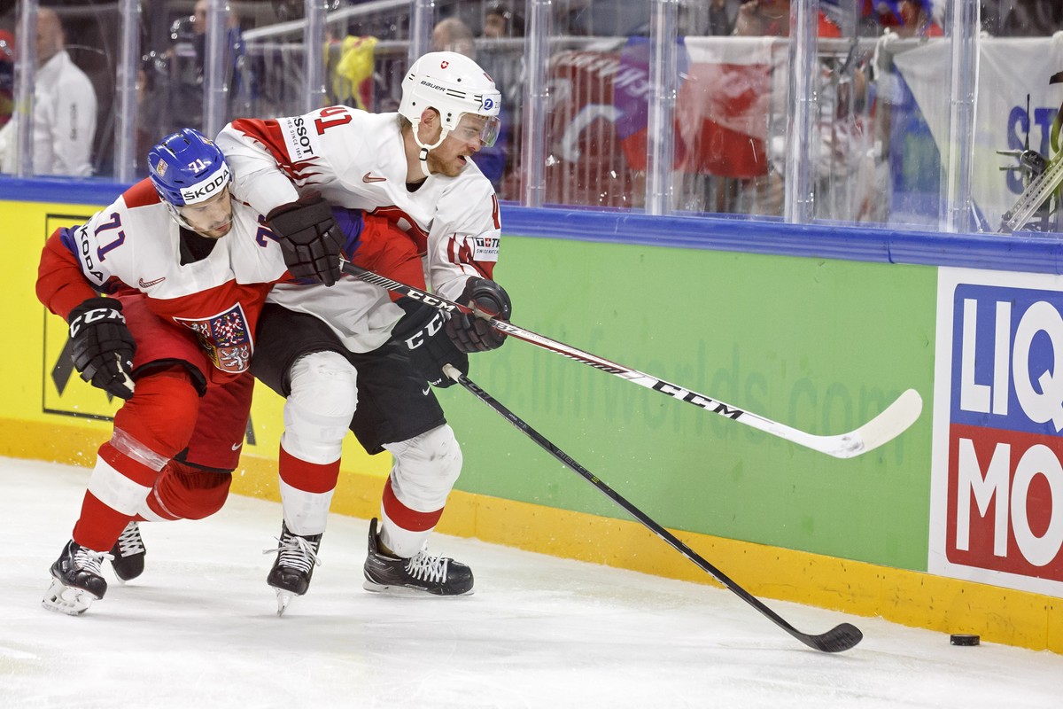 Czech Republic's forward Tomas Hyka, left, vies for the puck with Switzerland's defender Mirco Mueller, right, during the IIHF 2018 World Championship preliminary round game between Czech Re ...