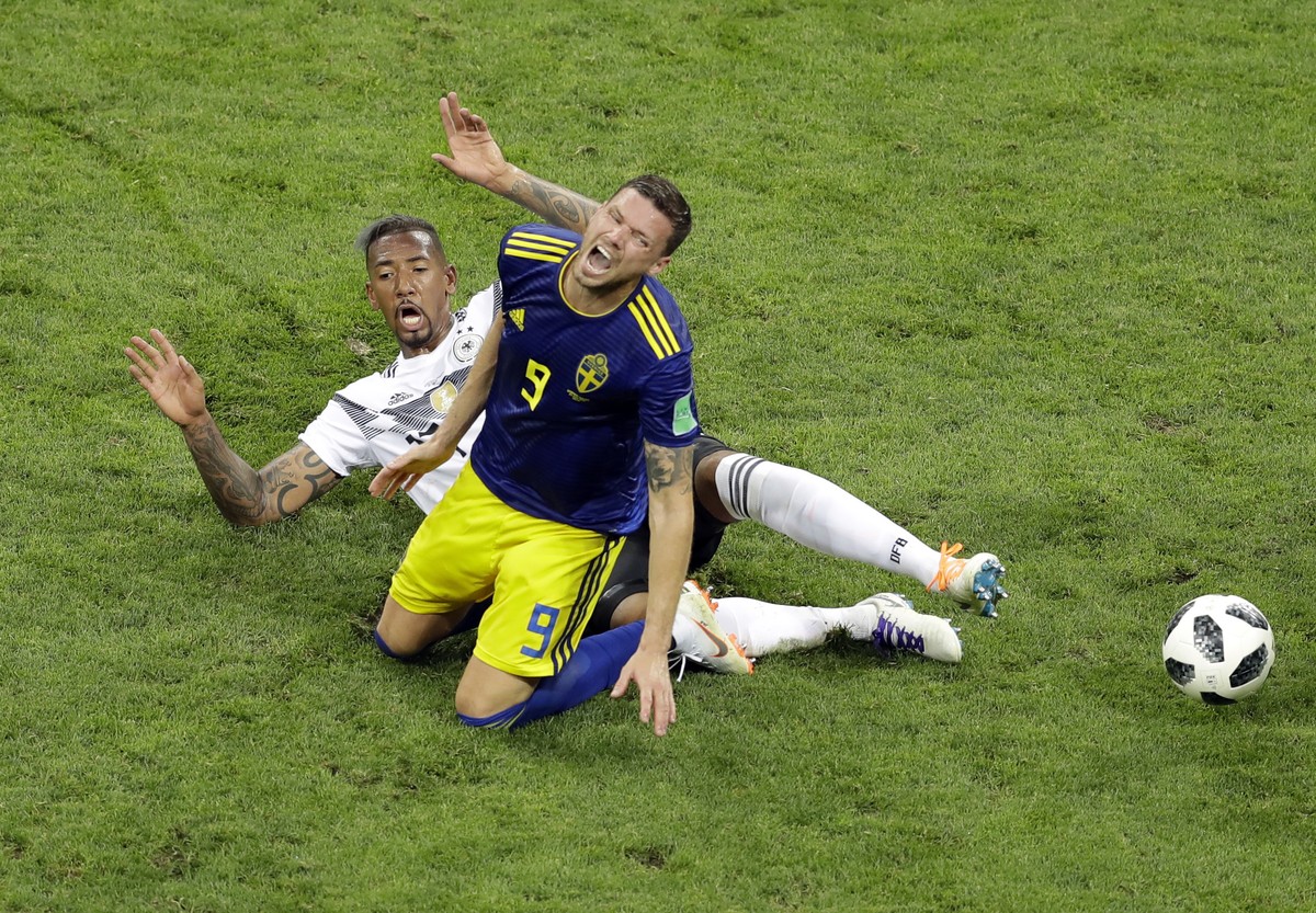 Sweden's Marcus Berg, front, is tackled by Germany's Jerome Boateng during the group F match between Germany and Sweden at the 2018 soccer World Cup in the Fisht Stadium in Sochi, Russia, Sa ...