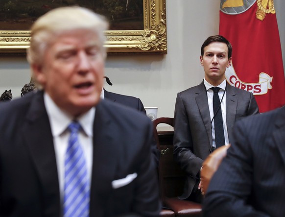 FILE - In this Jan. 23, 2017, file photo, White House Senior Adviser Jared Kushner listens at right as President Donald Trump speaks during a breakfast with business leaders in the Roosevelt Room of t ...