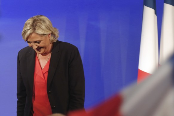 FILE - In this Sunday May 7, 2017 file photo, French far-right presidential candidate Marine Le Pen leaves after speaking at her election day headquarters in Paris. The forces of division are closing  ...