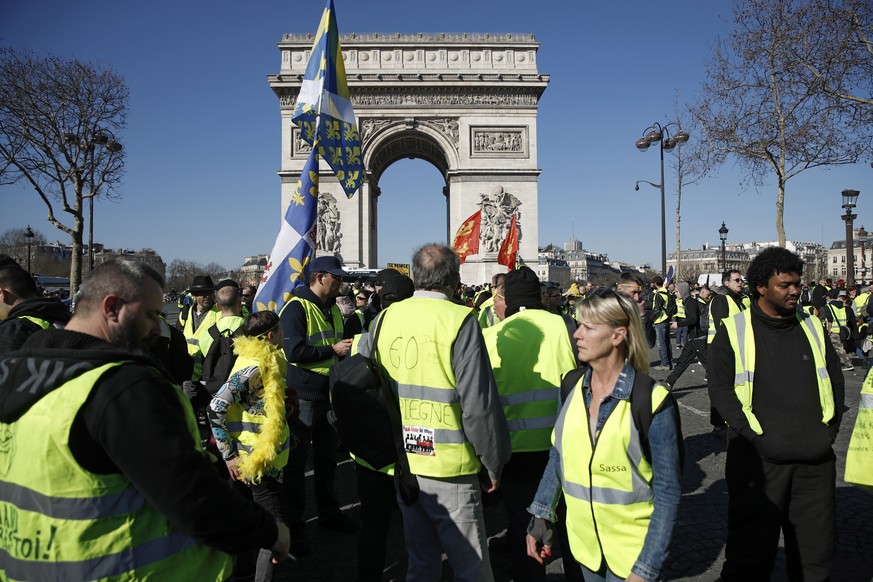 epa07389890 Protesters from the &#039;Gilets Jaunes&#039; (Yellow Vests) movement gather at the Champs Elysees as they take part in the &#039;Act XV&#039; demonstration (the 15th consecutive national  ...