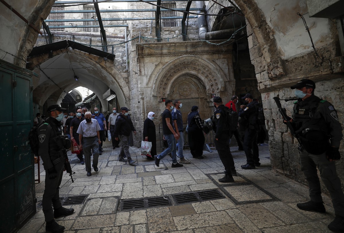 epa08767506 Palestinians making their way through the alleys of Jerusalem's Old city, to attend the Friday prayer at Al-Aqsa mosque compound , 23 October 2020. Israel began lifting of lockdown re ...