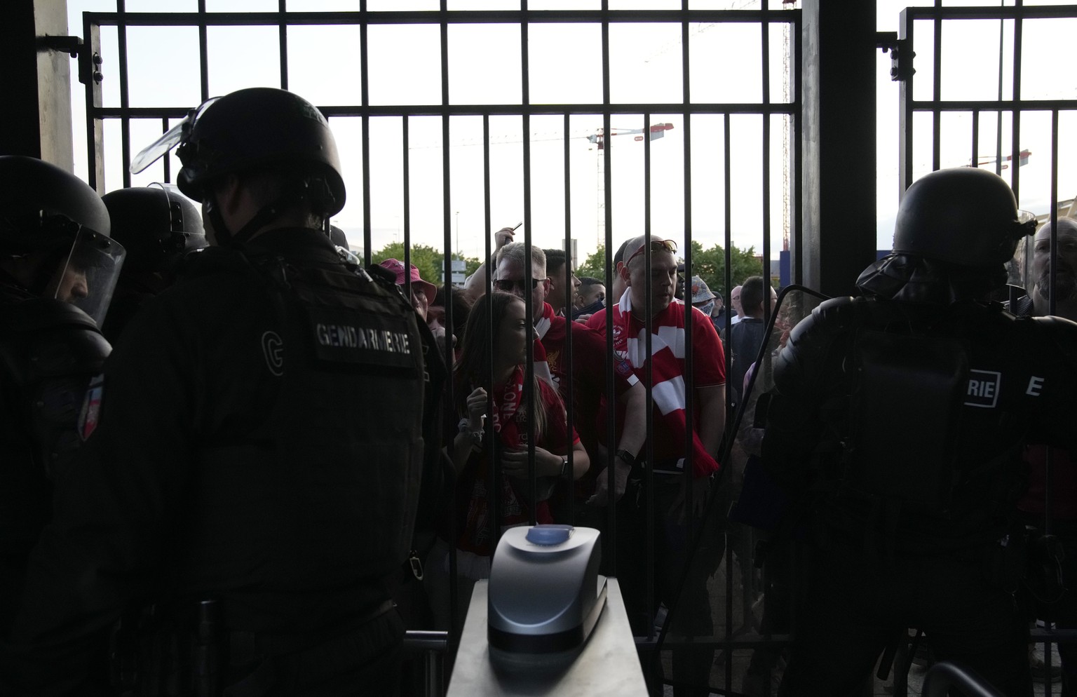 Liverpool fans wait in front of the of the Stade de France prior the Champions League final soccer match between Liverpool and Real Madrid, in Saint Denis near Paris, Saturday, May 28, 2022. (AP Photo ...