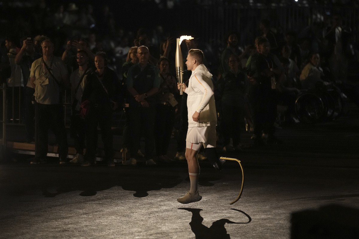 Markus Rehm carries the torch during the Opening Ceremony for the 2024 Paralympics, Wednesday, Aug. 28, 2024, in Paris, France. (AP Photo/Thibault Camus, Pool)