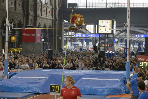 A person disguised as the mascot Cooly jumps during the mens pole vault competition at the main railway station in Zurich, Switzerland, Wednesday, September 2, 2015. The other competitions of the Wel ...
