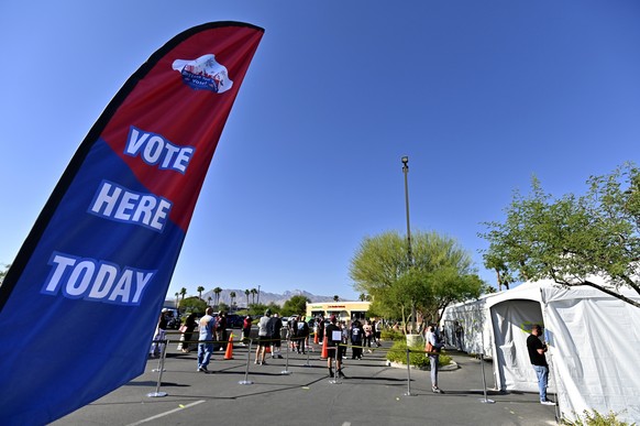 epa08796471 Voters wait in line to cast their ballot at a tented voting station in Las Vegas, Nevada, USA, 03 November 2020. Americans vote on Election Day to choose between re-electing Donald J. Trum ...