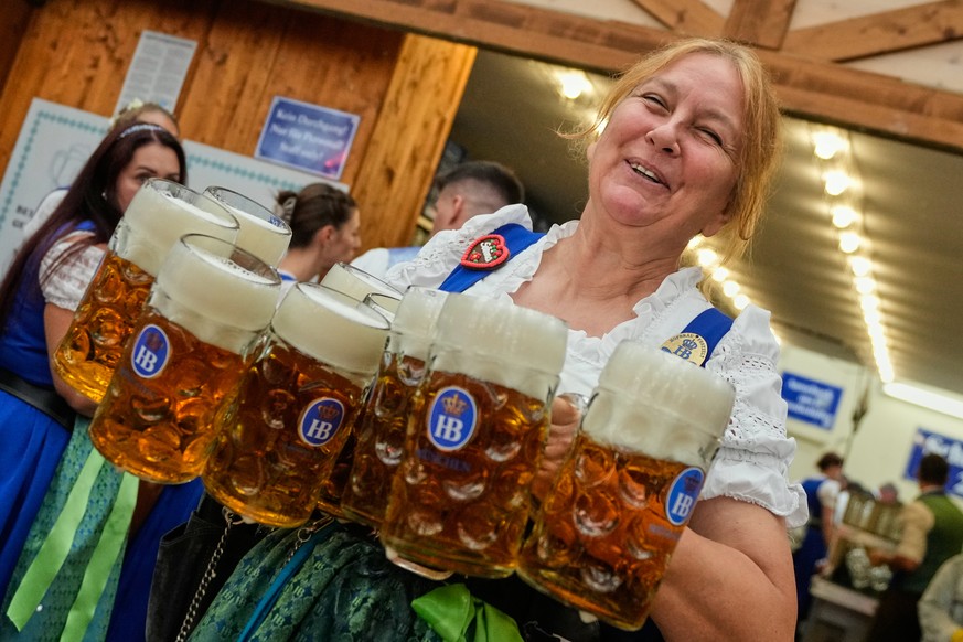 A waitress carries beer mugs after the opening of the 191st Oktoberfest beer festival in Munich, Germany, Saturday, Sept.19, 2026. (AP Photo/Matthias Schrader)
Germany Oktoberfest Opening