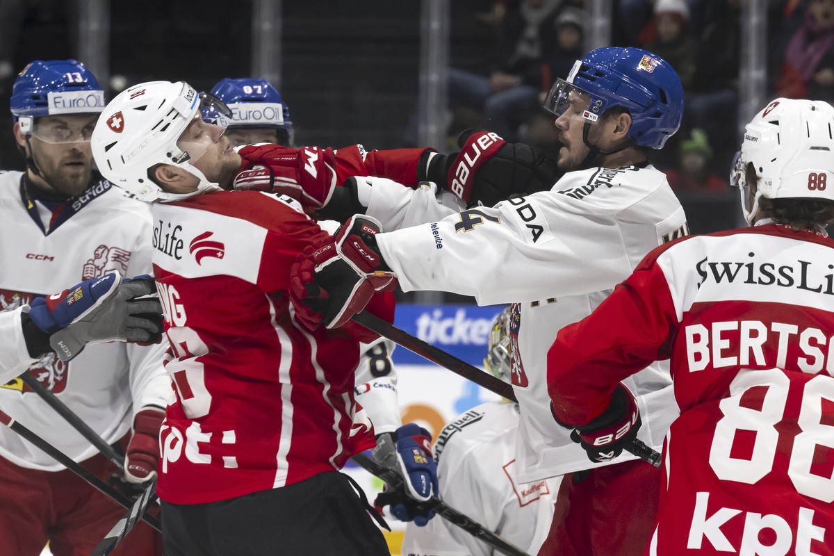 Switzerland's Sven Jung, left, reacts with Czechia's Tomas Kundratek, during the Euro Hockey Tour match between Czechia and Switzerland, at the BCF Arena in Fribourg, Switzerland, Saturday,  ...