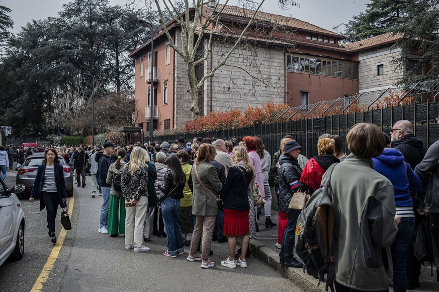 People queue outside the Russian consulate to vote for Russia&#039;s presidential election, in Milan, Italy, Sunday March 17, 2024. Russians at home and abroad are heading to the polls for a president ...