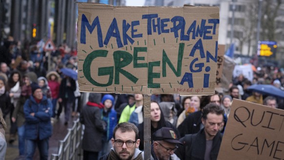 epa07203812 People carry placards as they take part in a demontration on Climate Change, in Brussels, Belgium, 02 December 2018. The demonstration takes place ahead of United Nations Climate Change Co ...