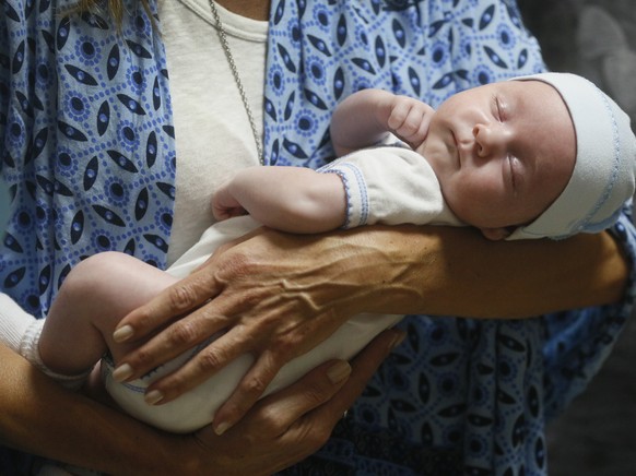 Andreo Diez, from Buenos Aires, Argentina, holds Ignacio, her baby born via a Ukrainian surrogate mother, after spending two weeks in quarantine, due to the coronavirus outbreak, in a hotel where the  ...