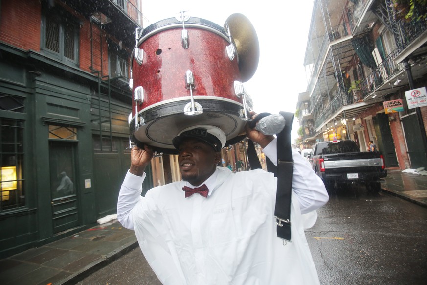 epa06251227 Sam Jackson walks his drum through the rain in the French Quarter as Hurricane Nate approaches New Orleans, Louisiana, USA on 7 October 2017. Reports state that a state of emergency has be ...