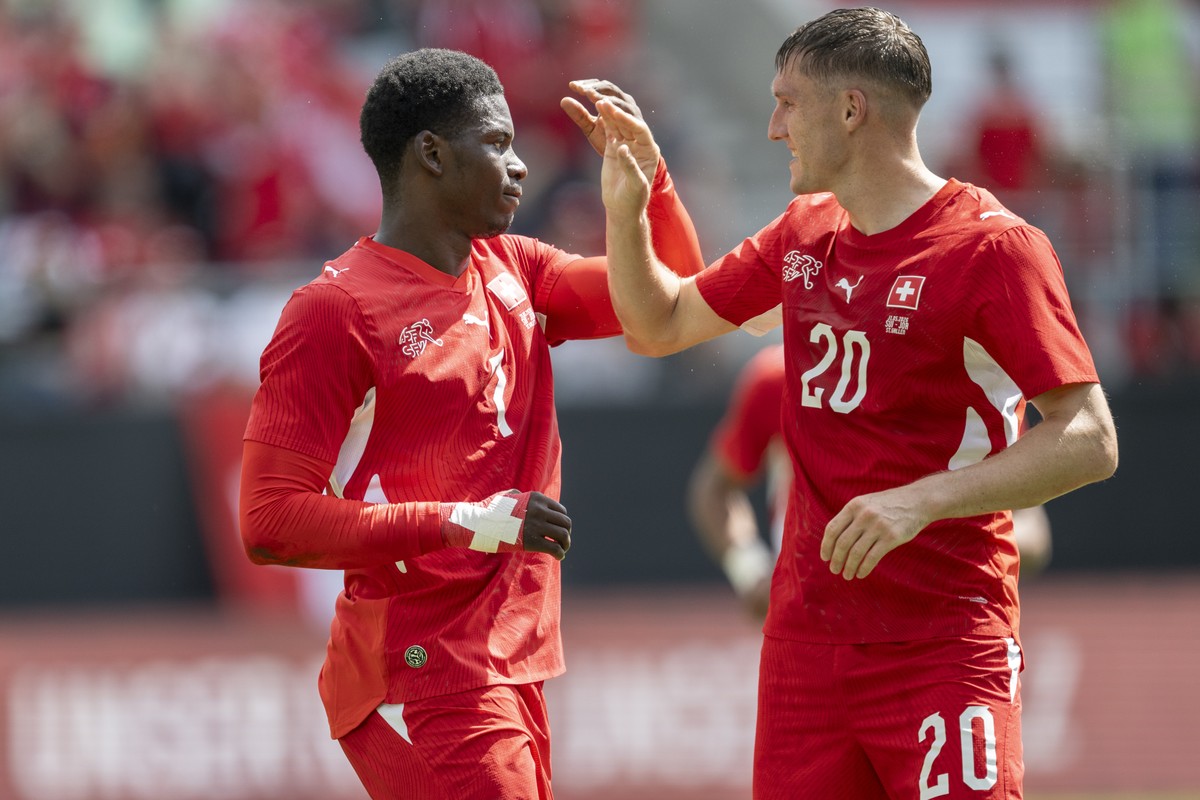 Switzerland's Breel Embolo, left, and Michel Aebischer celebrate after scoring 1-0 during the friendly soccer match between Switzerland and Jordan, at the kybunpark, in St. Gallen, Switzerland, S ...