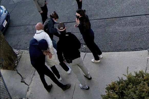 In this image taken from security camera video, Rumeysa Ozturk, a 30-year-old doctoral student at Tufts University, is detained by Department of Homeland Security agents on a street in Sommerville, Ma ...
