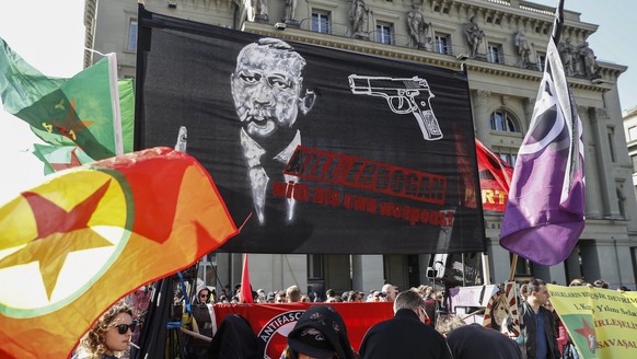 epa05870520 A banner reads; &#039;Kill Erdogan with his own weapons&#039;, as protesters march during a demonstration against the Turkish President Recep Tayyip Erdogan, in Bern, Switzerland, 25 March ...