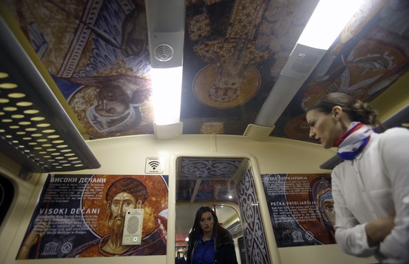 A train hostess stands in a train carriage decorated with the iconic figures as it departs from Belgrade to Mitrovica, Kosovo at Belgrade&#039;s railway station, Serbia, Saturday, Jan. 14, 2017. Serbi ...