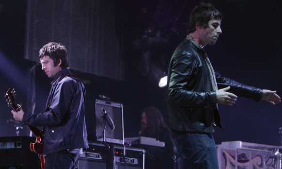 FILE - Noel, left, and Liam Gallagher, of Oasis, perform during the start of their Canadian tour in Vancouver, B.C., on Aug. 27, 2008. (Darryl Dyck/The Canadian Press via AP, File)