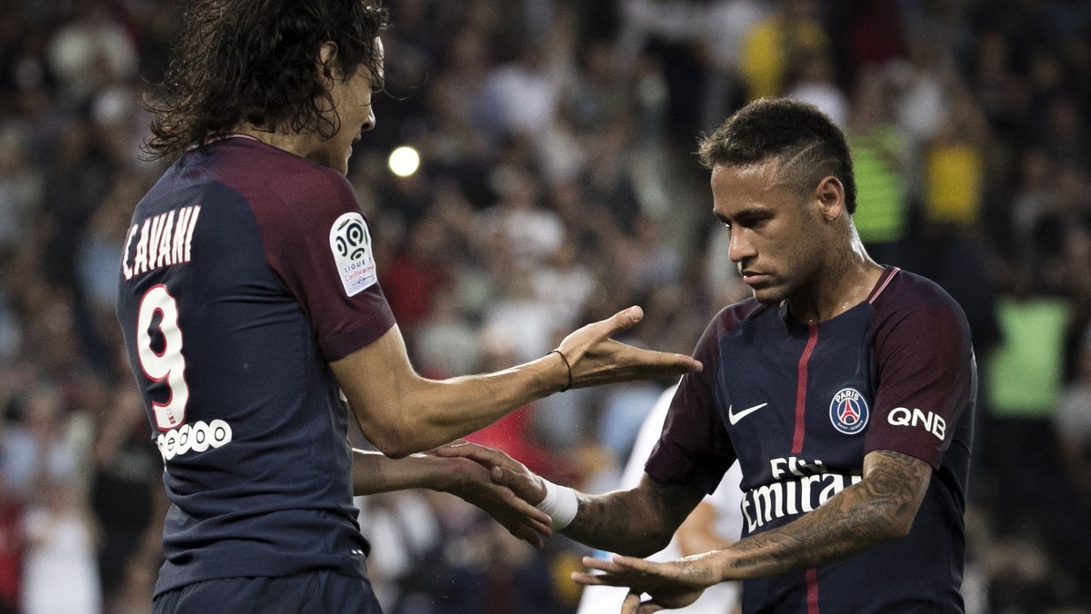PSG's Edinson Cavani, left, reacts with teammate Neymar after a goal was scored, during the French League One soccer match between Paris Saint Germain and Saint Etienne at the Parc des Princes st ...