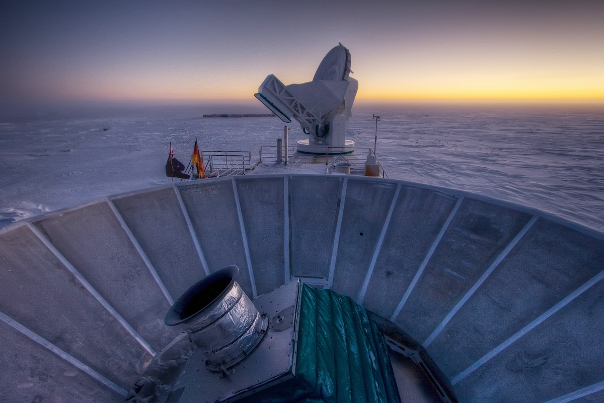 In this 2007 photo provided by Steffen Richter, the sun sets behind the BICEP2 telescope, foreground, and the South Pole Telescope in Antarctica. In the faint glowing remains of the Big Bang, scientis ...