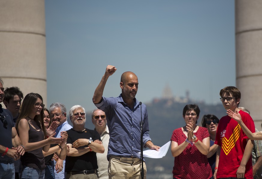 Manchester City coach Pep Guardiola gestures after delivering a speech during a protest organised by the National Assembly for Catalonia, to support the call for referendum in Barcelona, Spain, Sunday ...