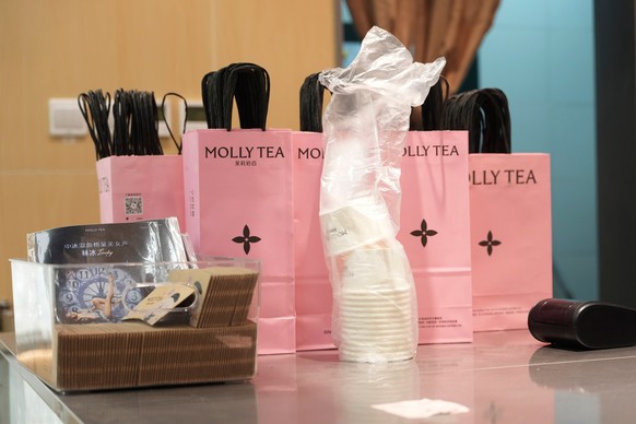 Bags with the Molly Tea brand and logo are seen at a shop in Beijing, China, Tuesday, July 7, 2026. (AP Photo/Ng Han Guan)
China Louis Vuitton