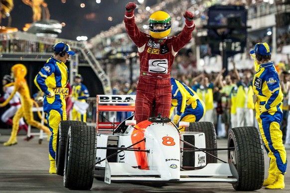 RIO DE JANEIRO, BRAZIL - MARCH 03: Members of Unidos da Tijuca Samba School during their parade at 2014 Brazilian Carnival at Sapucai Sambadrome on March 03, 2014 in Rio de Janeiro, Brazil. Rio's two nights of Carnival parades began on March 2 in a burst of fireworks and to the cheers of thousands of tourists and locals who have previously enjoyed street celebrations (known as "blocos de rua") all around the city. (Photo by Buda Mendes/Getty Images)