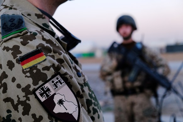 epa09675961 German Bundeswehrs soldiers wait for the arrival of Christine Lambrecht, the Germany Defense minister during her visit to Erbil, the capital of the Kurdistan Region in Iraq, 09 January 202 ...