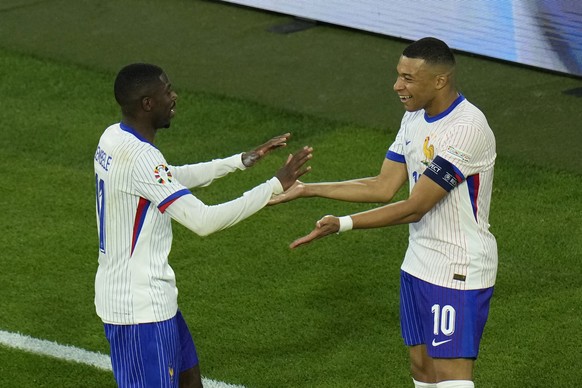 Kylian Mbappe of France, right, celebrates with Ousmane Dembele of France after Austria&#039;s Maximilian Wober scored an own goal during a Group D match between Austria and France at the Euro 2024 so ...