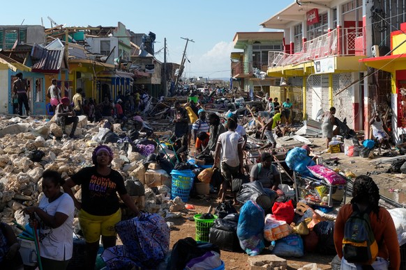 Residents gather amid debris in the aftermath of Hurricane Melissa on a street in Black River, Jamaica, Thursday, Oct. 30, 2025. (AP Photo/Matias Delacroix)
Jamaica Extreme Weather