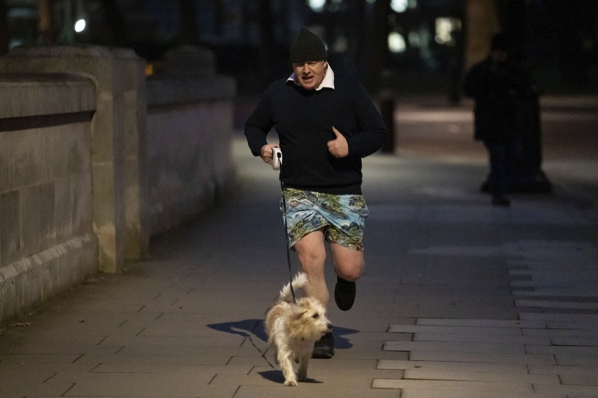 Britain&#039;s Prime Minister Boris Johnson jogs in central London, early Monday, Jan. 24, 2022. (Aaron Chown/PA via AP)