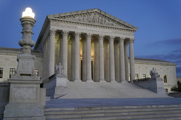 FILE - Light illuminates part of the Supreme Court building at dusk on Capitol Hill in Washington, Nov. 16, 2022. The court is set to hear arguments on Dec. 7 in a case from North Carolina, where Repu ...