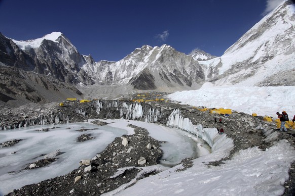 FILE - Tents are set up for climbers on Khumbu Glacier, with Mount Khumbutse in the center, and Khumbu Icefall, right, seen in the background, at Everest Base Camp in Nepal on April 11, 2015. As glaciers me...