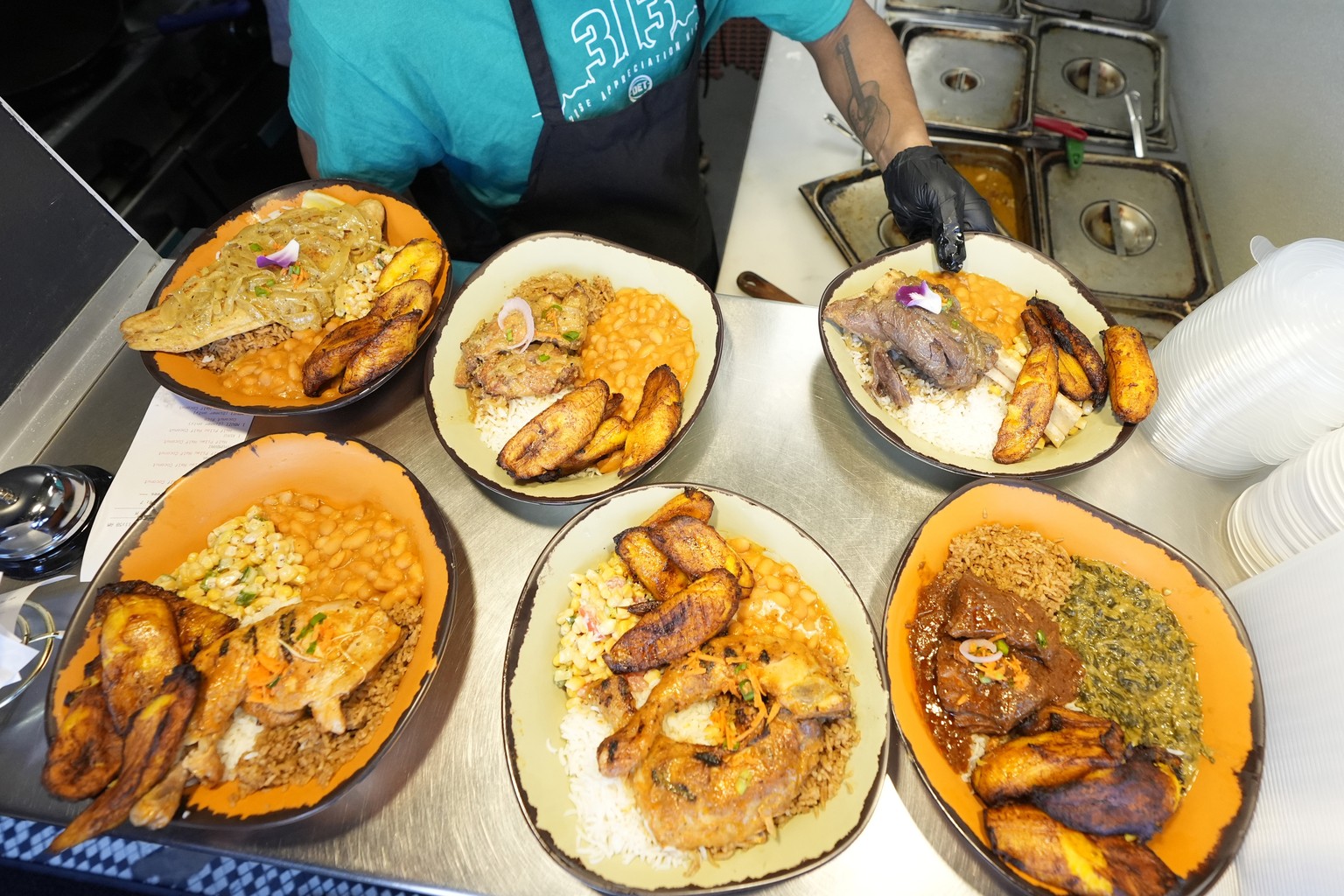 A sampling of East African cuisine is prepared at the Baobab Fare restaurant, Friday, May 24, 2024, in Detroit. For Hamissi Mamba and Nadia Nijimbere _ who own Baobab Fare in Detroit _ a win among the ...