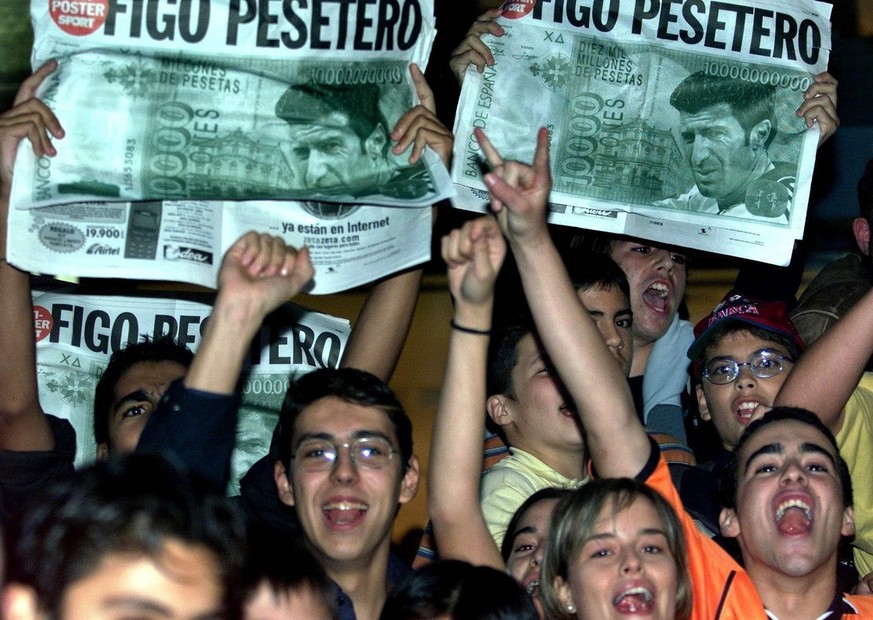 Portuguese soccer player Luis Figo holds up the Real Madrid shirt he will be wearing next season after being presented to the press at the Bernabeu stadium in Madrid, Spain Monday, July 24, 2000. Figo ...