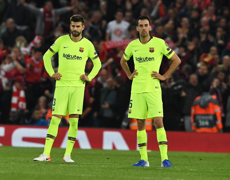 epa07554630 Gerard Pique (L) and Sergio Busquets of Barcelona react during the UEFA Champions League semi final second leg soccer match between Liverpool FC and FC Barcelona at Anfield, Liverpool, Bri ...