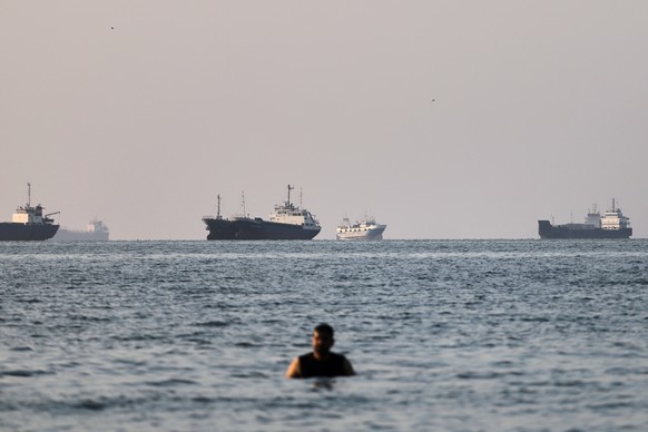 A person stands in shallow water as cargo and commercial vessels are anchored in the Strait of Hormuz off Bandar Abbas, Iran, Monday, June 8, 2026. (Amirhosein Khorgooi/ISNA via AP)
APTOPIX Iran War S ...