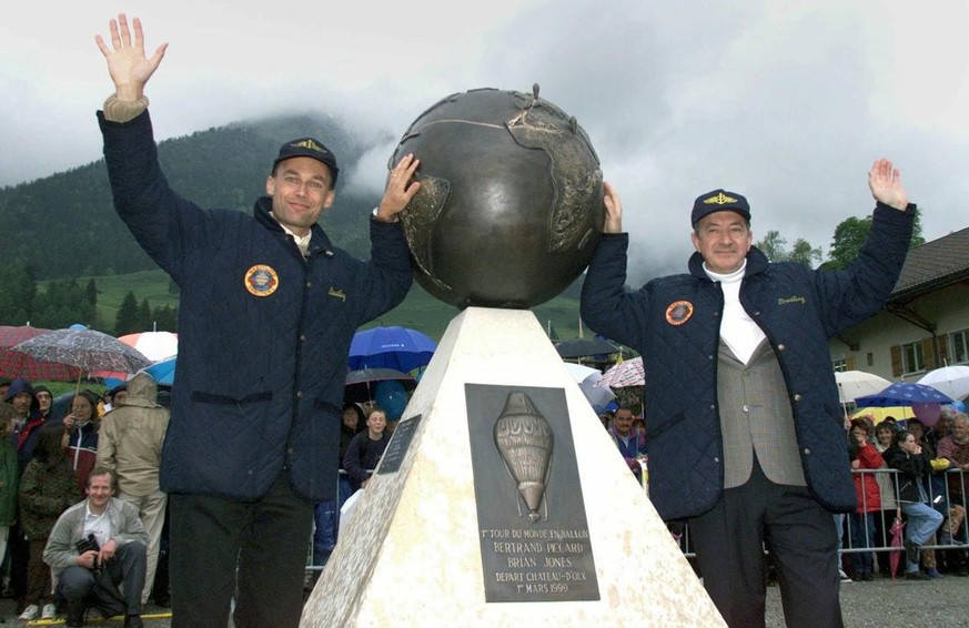 Hot air balloon pilots Swiss Bertrand Piccard (left) and British Brian Jones smile after they revealed a monument during a reception ceremony at Chateau d&#039;Oex, Switzerland, Friday, May 21, 1999.  ...