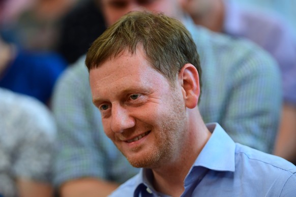 epa07793242 Saxony State Premier Michael Kretschmer of the Christian Democratic Union (CDU) during a panel discussion with coal miners at the IG BCE trade union headquarters in Dresden, Germany, 25 Au ...