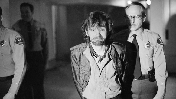 FILE - In this Dec. 21, 1970 file photo, Charles Manson reacts to photographers as he goes to lunch after an outbreak in court that resulted in his ejection, along with three female co-defendants, in  ...