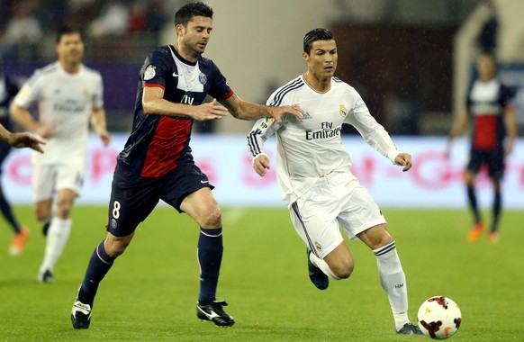 DOHA, Jan. 2, 2014 - Cristiano Ronaldo (R) of Real Madrid vies for the ball during a friendly football match against Paris Saint-Germain in Doha, Qatar, Jan. 2, 2014. Real Madrid won 1-0. (Xinhua/Chen ...